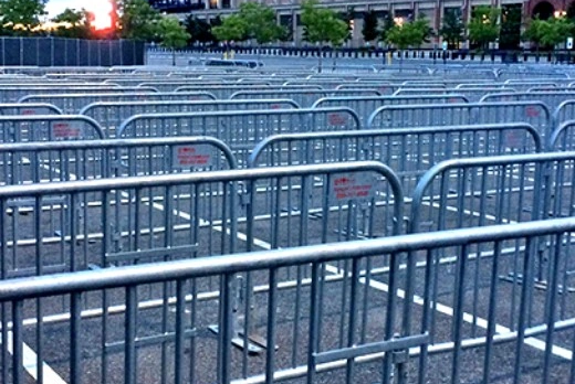Stacked powder-coated metal barricades ready for deployment